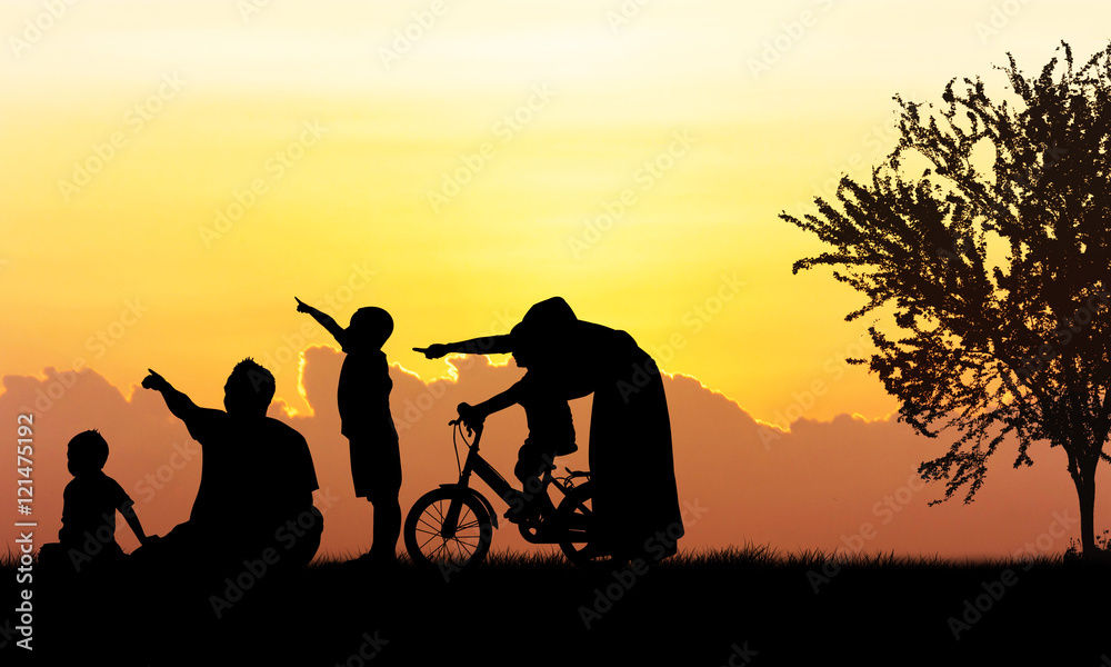 Silhouette of Happy family playing in field sunset background