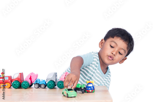 Cute little boy play toy car
