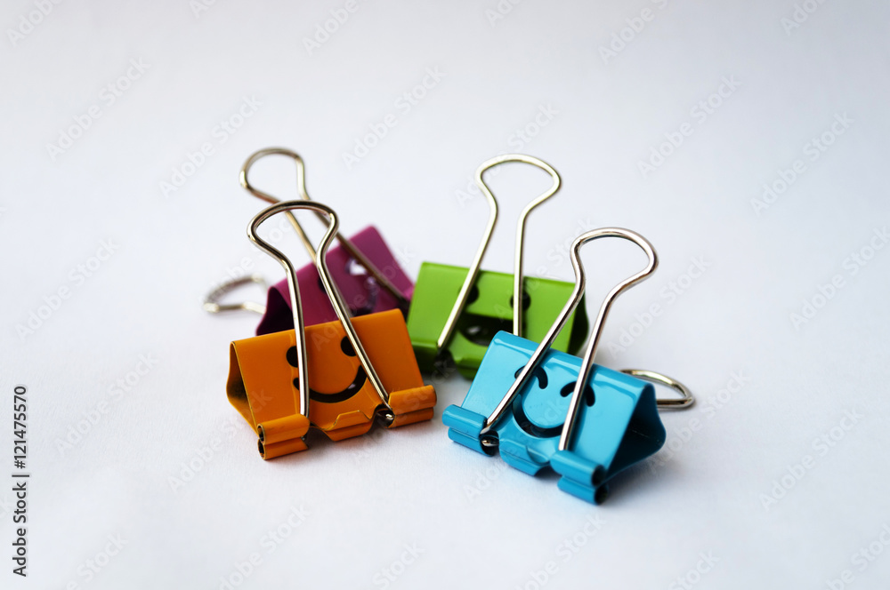 Colorful binder clip isolated on white background, selective foc Colorful binder clip isolated on white background, selective foc