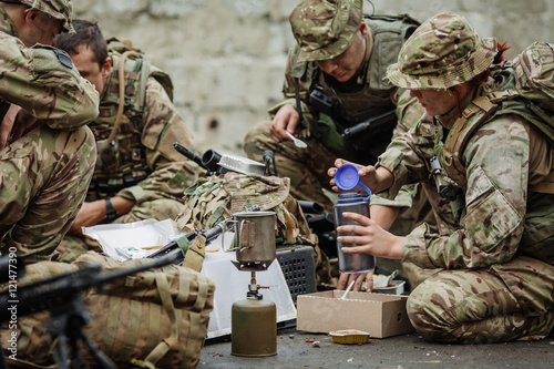 british soldiers team eating on the battlefield © kaninstudio