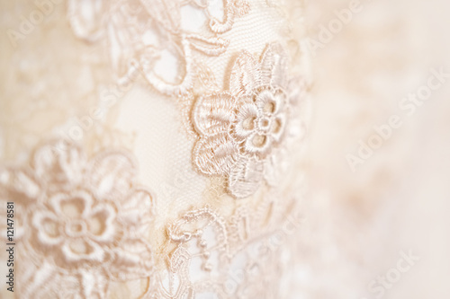 Background, texture, embroidered lace. Delicate detail of a wedding dress. Fine lace