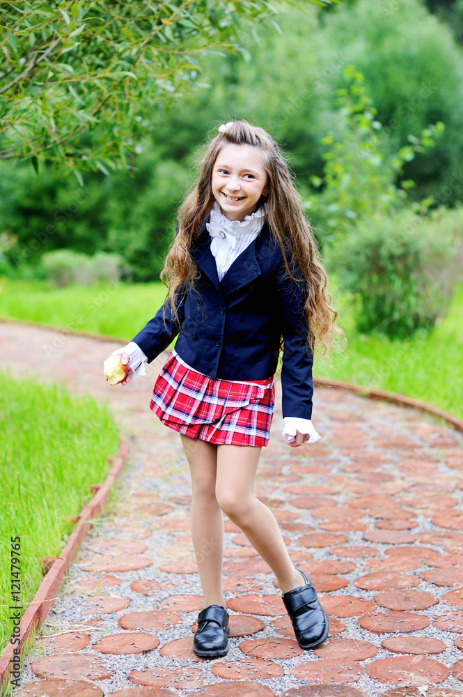 Happy schoolgirl in school uniform Stock