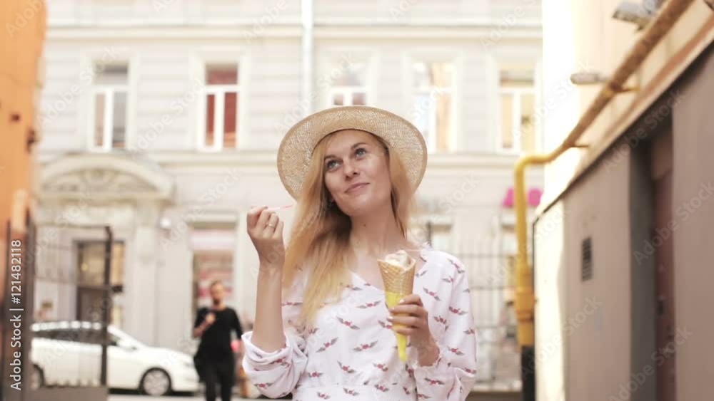 Beautiful Woman Eating Ice Cream on a Summer Day Outdoors Beautiful Woman Eating Ice Cream on a Summer Day Outdoors