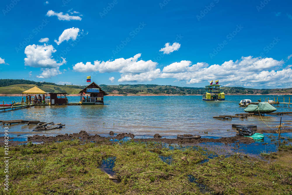 boats and a hut on a tranquil lake in the morning