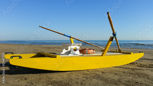 Fototapeta Naklejka Na Ścianę i Meble -  Yellow rescue boat on Italian beach. Adriatic sea.