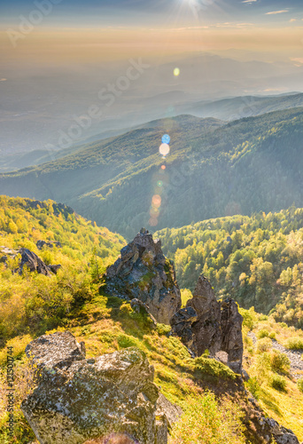 Beautiful rocks on a hill top and sunshine from the top corner - amazing autumn scenery at Vitosha, Sofia, Bulgaria