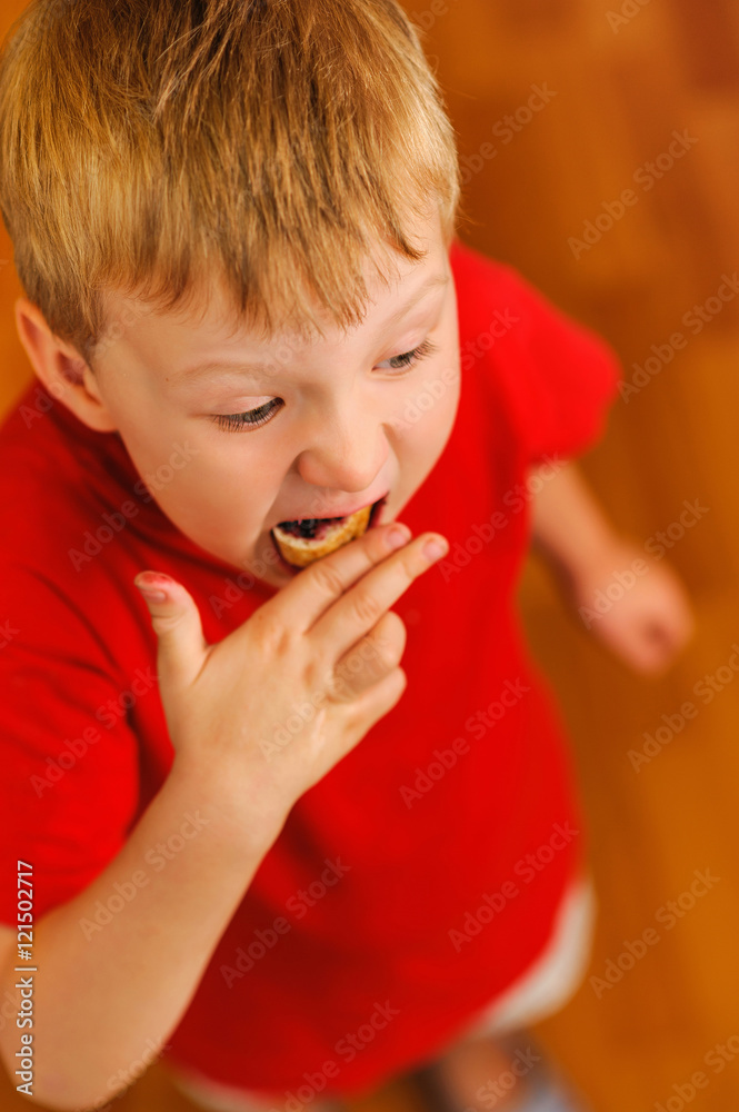 kid eating bread with bilberry jam kid eating bread with bilberry jam