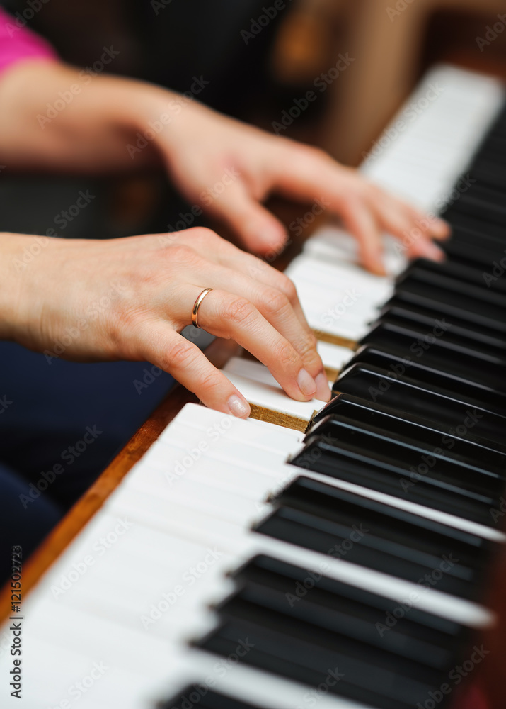 woman hands on a piano key woman hands on a piano key