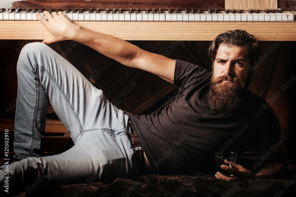 bearded man with glass near wood piano bearded man with glass near wood piano
