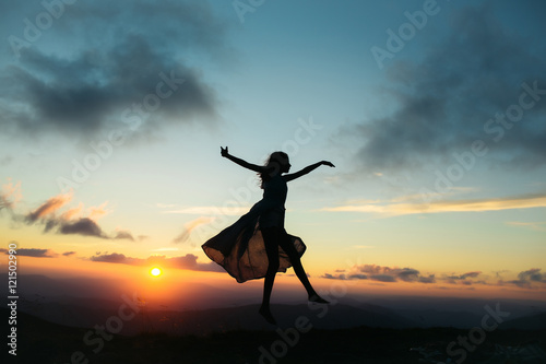 woman at sunset or sunrise in mountains