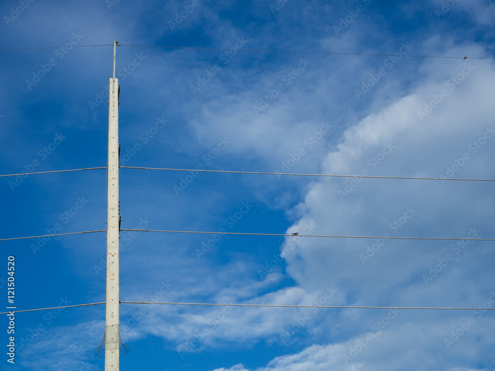 Tall and high concrete electric pole with power line cables Tall and high concrete electric pole with power line cables
