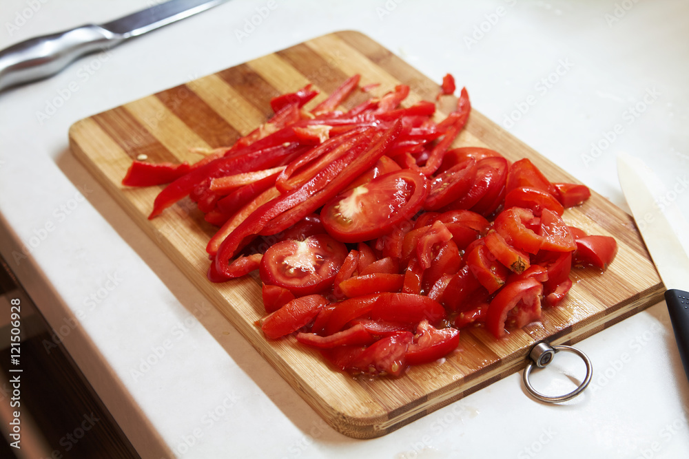 Chopped red bell pepper on a wooden cutting board. Chopped red bell pepper on a wooden cutting board.