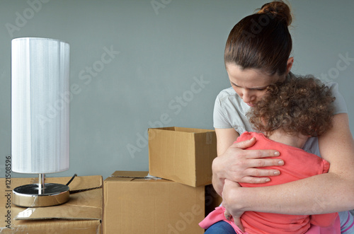 Sad evicted mother with child worried relocating house photo