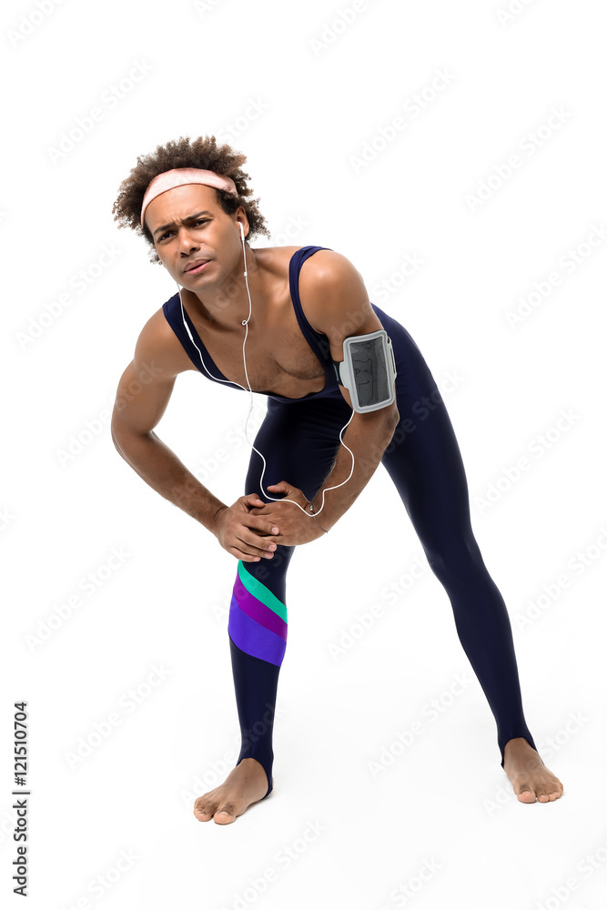 Tired sportive african man warming up over white background. Tired sportive african man warming up over white background.
