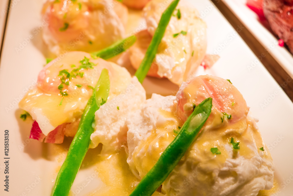 Eggs Benedict- toasted English muffins, ham, poached eggs aspara