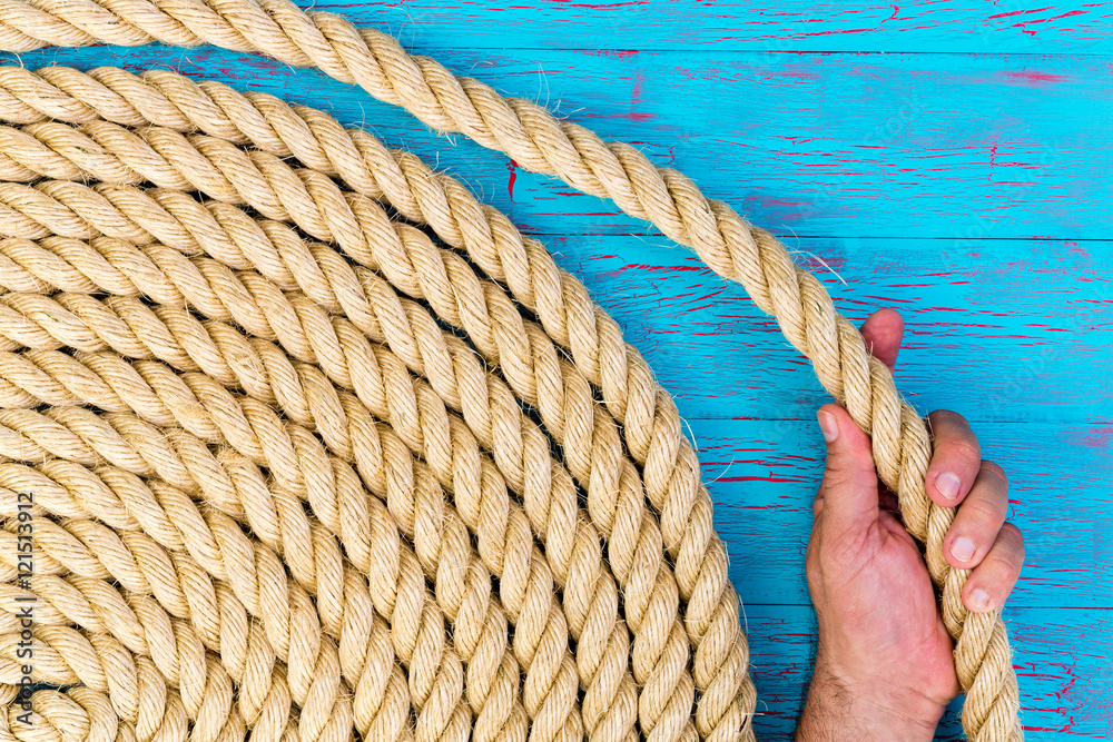 Man holding a loop of a coiled rope Stock Photo | Adobe Stock