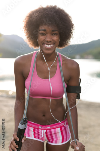 portrait of afro female runner cross training on beach