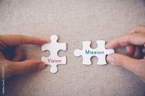 Hands with puzzle pieces and "Vision and Mission" words