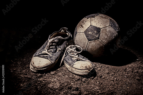 Ragged sneakers with a soccer ball