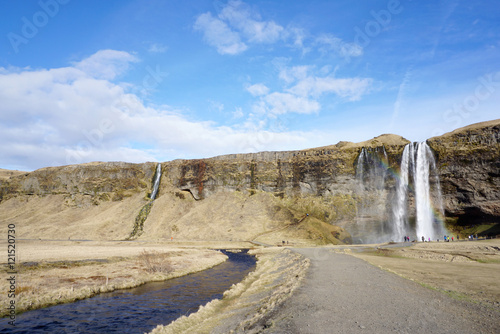 Beautiful  Seljalandsfoss waterfall with river and meadow