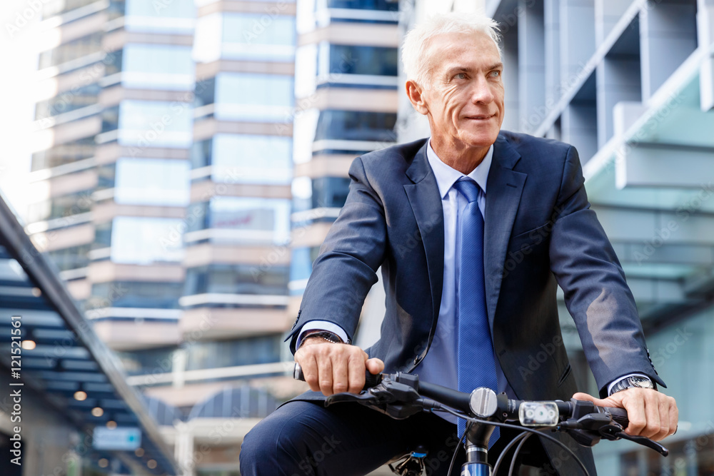 Successful businessman riding bicycle Successful businessman riding bicycle