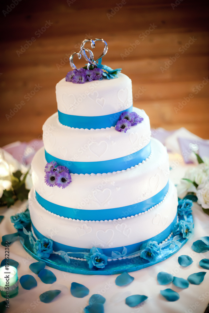 Colorful blue and purple wedding cake with silver wedding topper Colorful blue and purple wedding cake with silver wedding topper