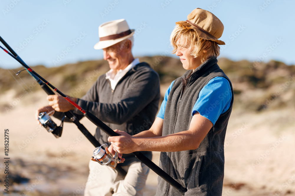 Fototapeta premium Senior man fishing with his grandson