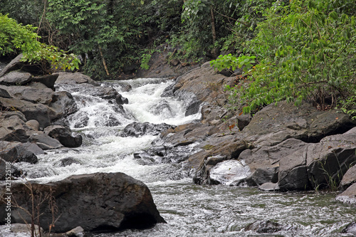Photography Salaulim river, a tributary of Zuari River, flowing through the rugged and hilly forest area of Netravali in Goa, India