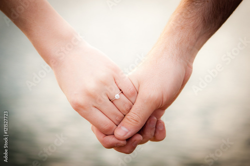 Close up of Young Couple holding hands