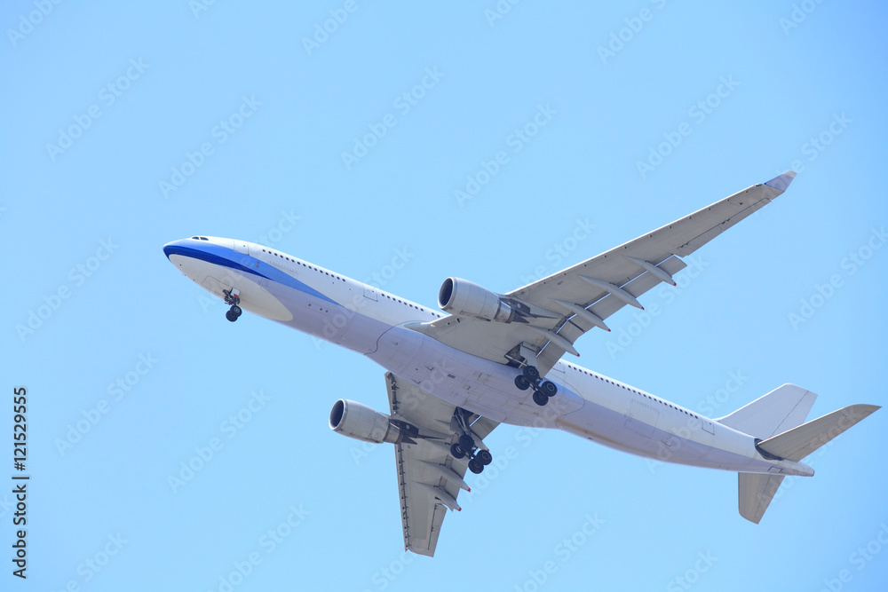 Airplane taking off bottom view and blue sky