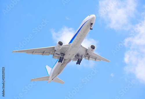 Airplane taking off bottom view and blue sky