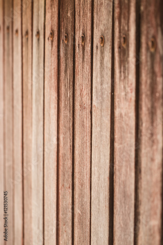 old wood panel wall vertical pattern with rusty nail.