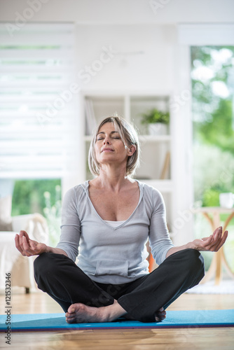 Free Download a pretty retired woman who does yoga at home, she meditates - GFXLoad