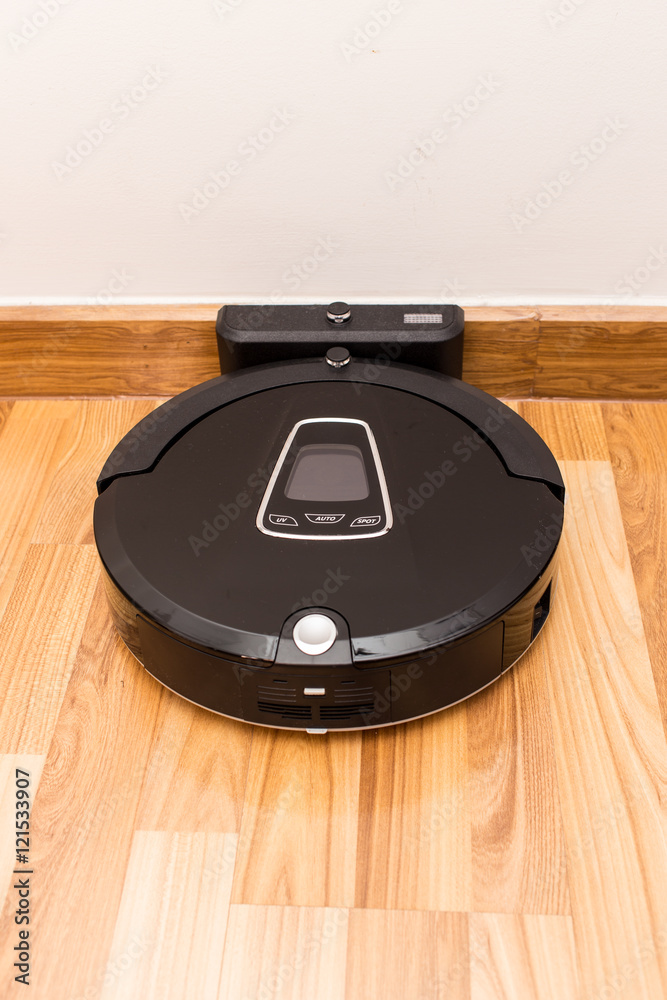 Robotic vacuum cleaner on wood parquet floor, Smart vacuum, new automate  technology housework - Auto charging at dock station. Stock Photo | Adobe  Stock