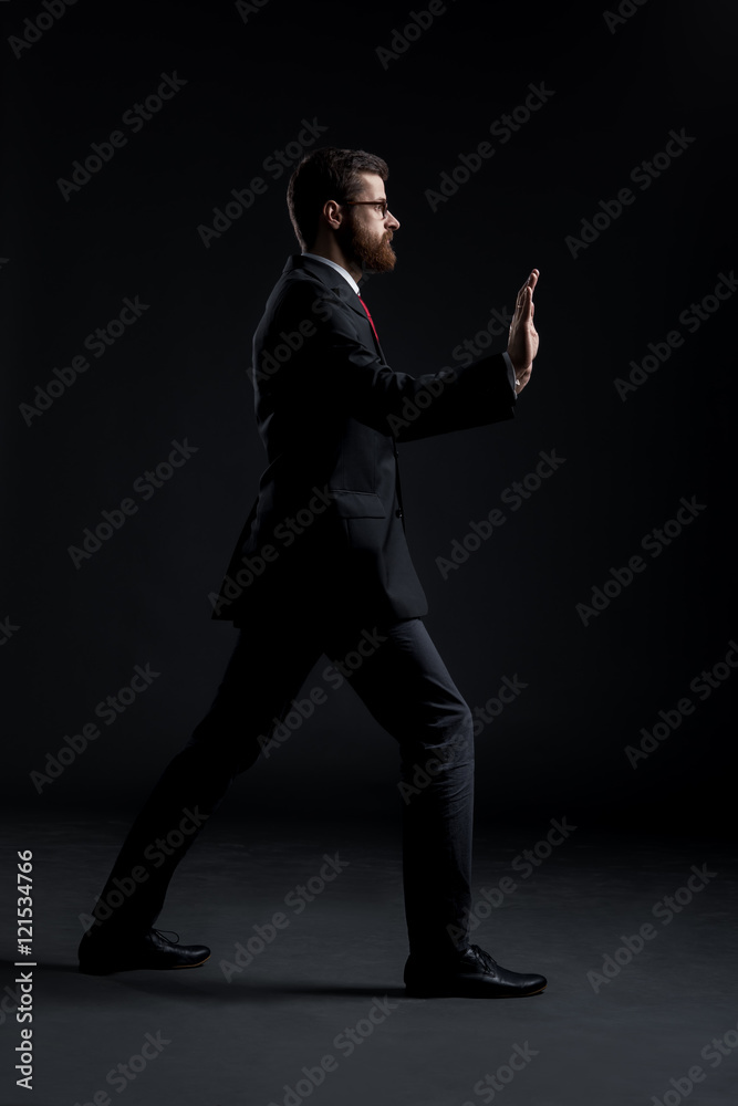 Businessman pushing something imaginary on black Businessman pushing something imaginary on black
