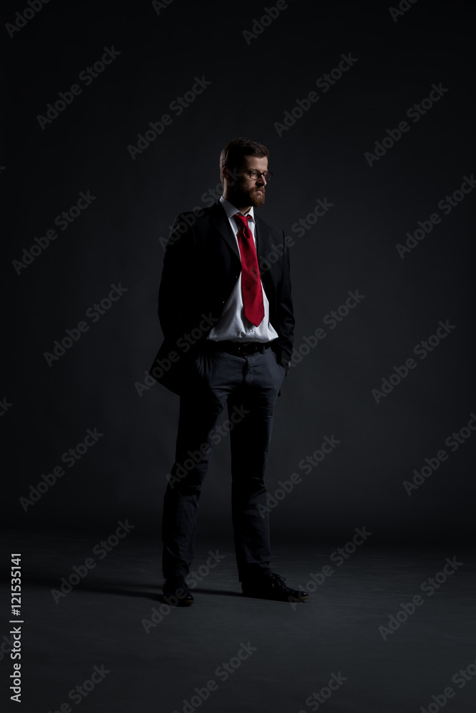 Businessman standing on a black background Businessman standing on a black background