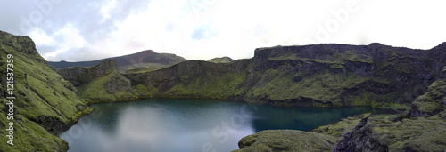 Lake in Tjarnargigur volcano crater photo