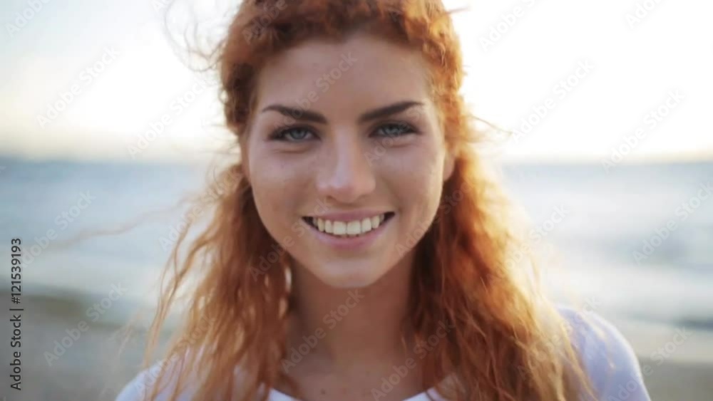 happy young redhead woman face on beach happy young redhead woman face on beach