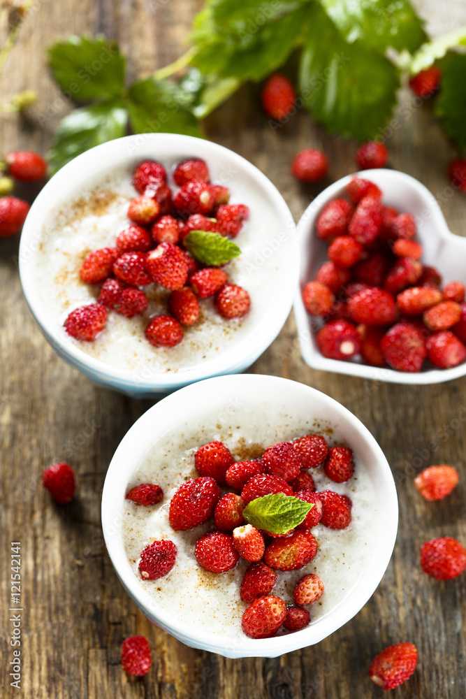 Rice pudding or Milchreis with wild strawberry Rice pudding or Milchreis with wild strawberry