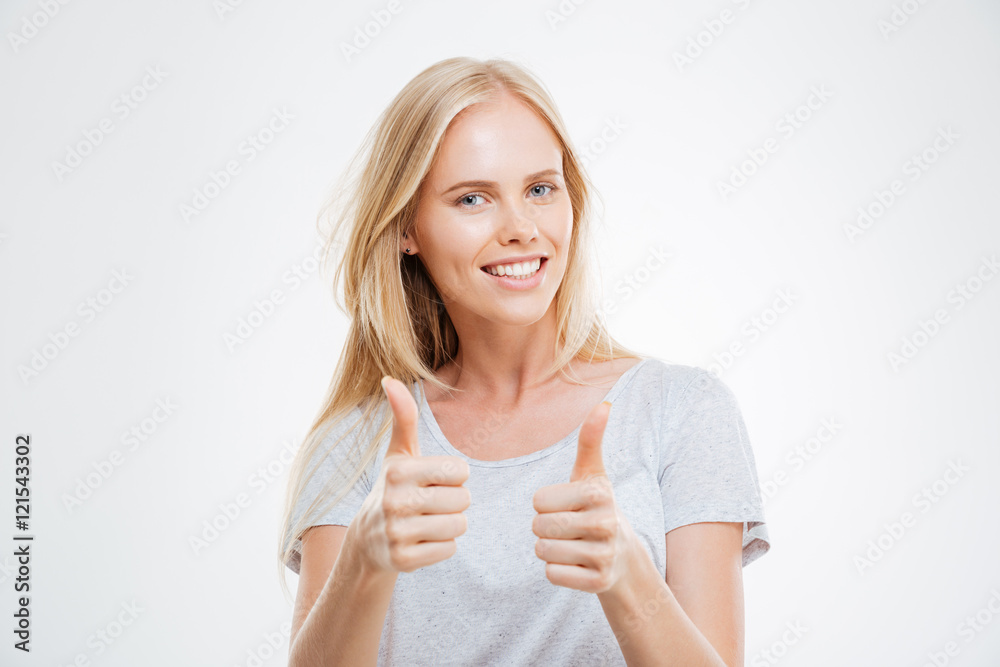 Smiling pretty young woman showing thumbs up Smiling pretty young woman showing thumbs up