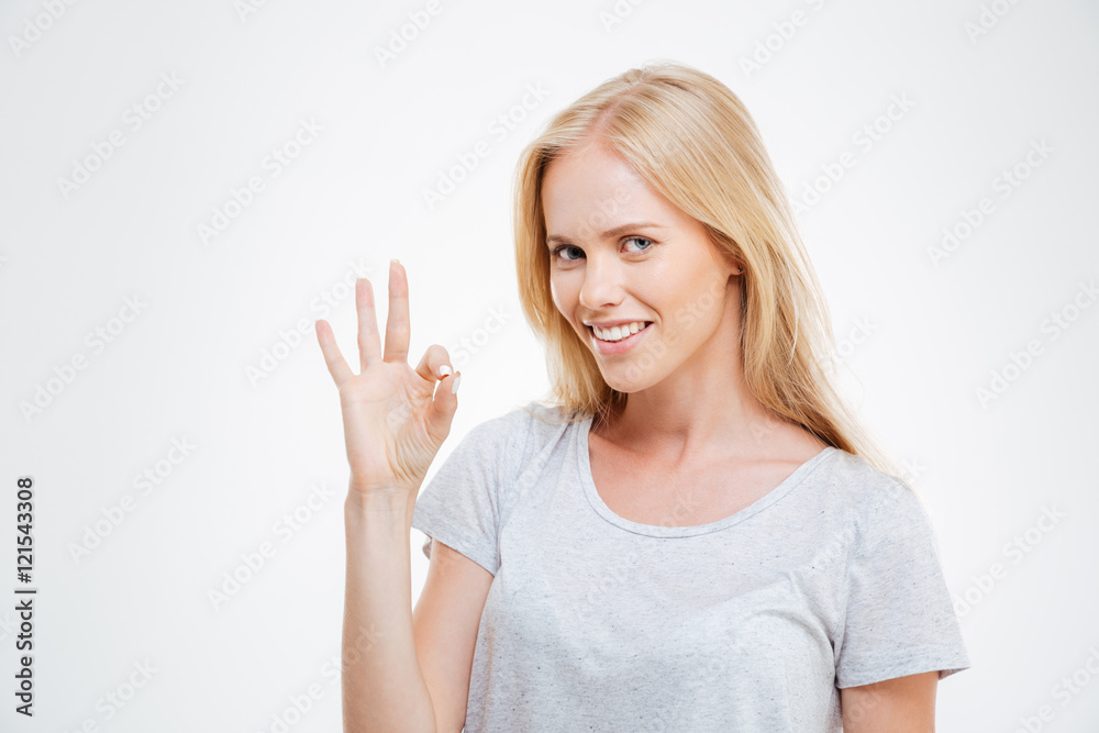 Smiling blonde woman showing ok sign isolated Smiling blonde woman showing ok sign isolated