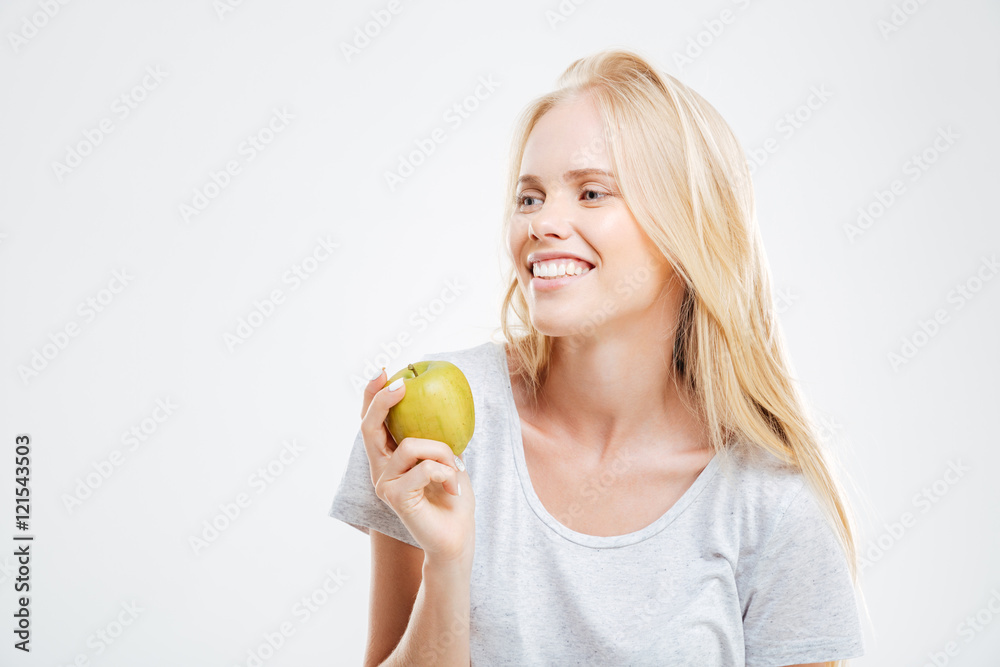 Portrait of a smiling young girl holding green apple Portrait of a smiling young girl holding green apple