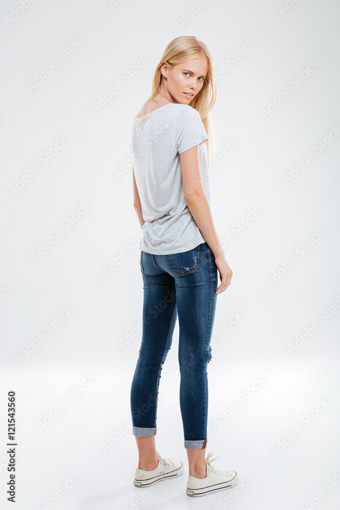 Full length portrait of a woman looking back at camera Full length portrait of a woman looking back at camera