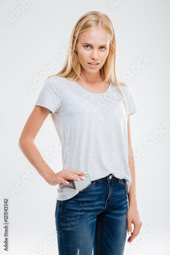 Beautiful young blonde girl putting smartphone in the jeans pocket © Drobot Dean