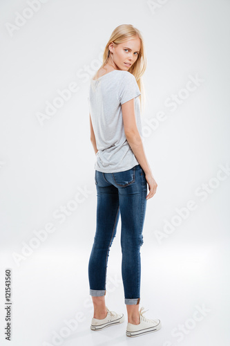 Full length portrait of a woman looking back at camera