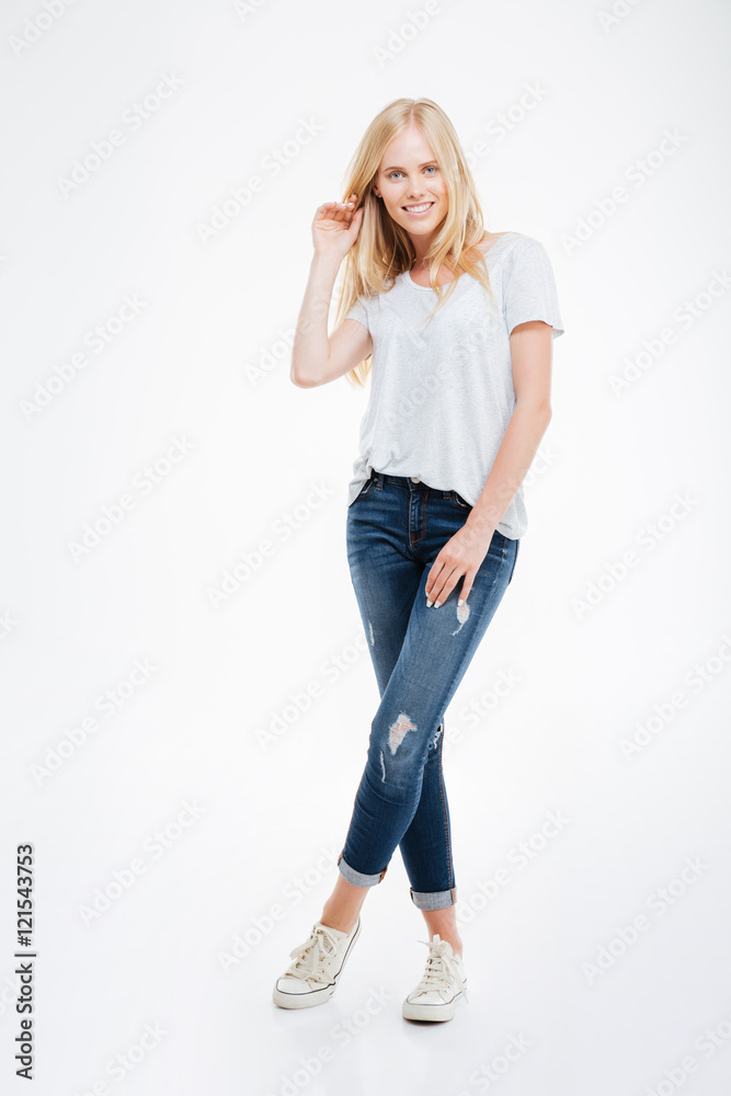 Full length portrait of a woman standing with legs crossed Full length portrait of a woman standing with legs crossed