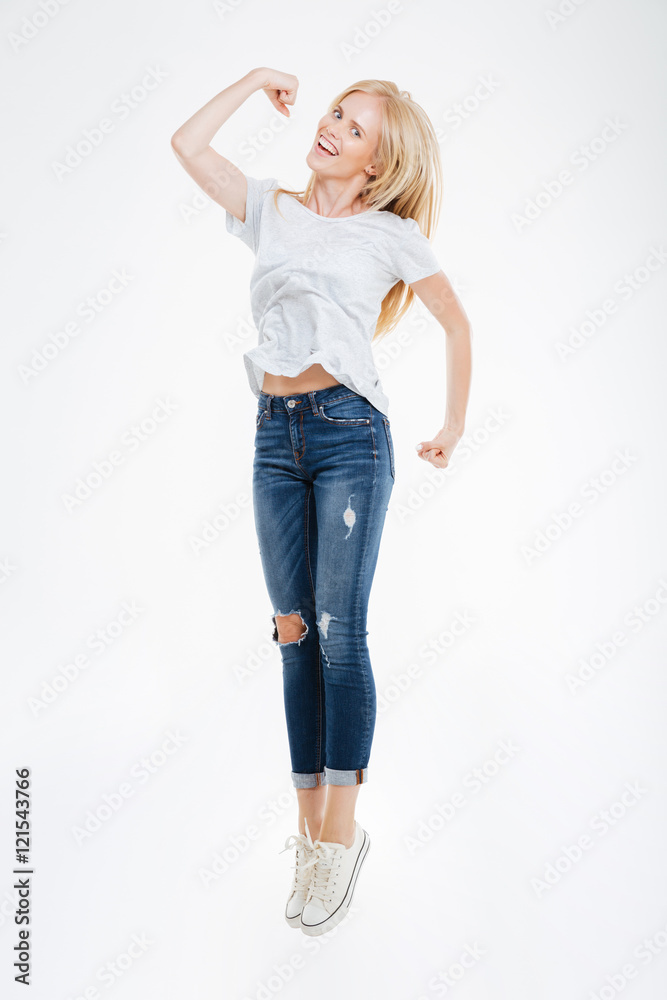 Full length portrait of a cheerful happy woman jumping Full length portrait of a cheerful happy woman jumping