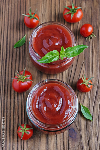 Tomato sauce and basil in glass jars