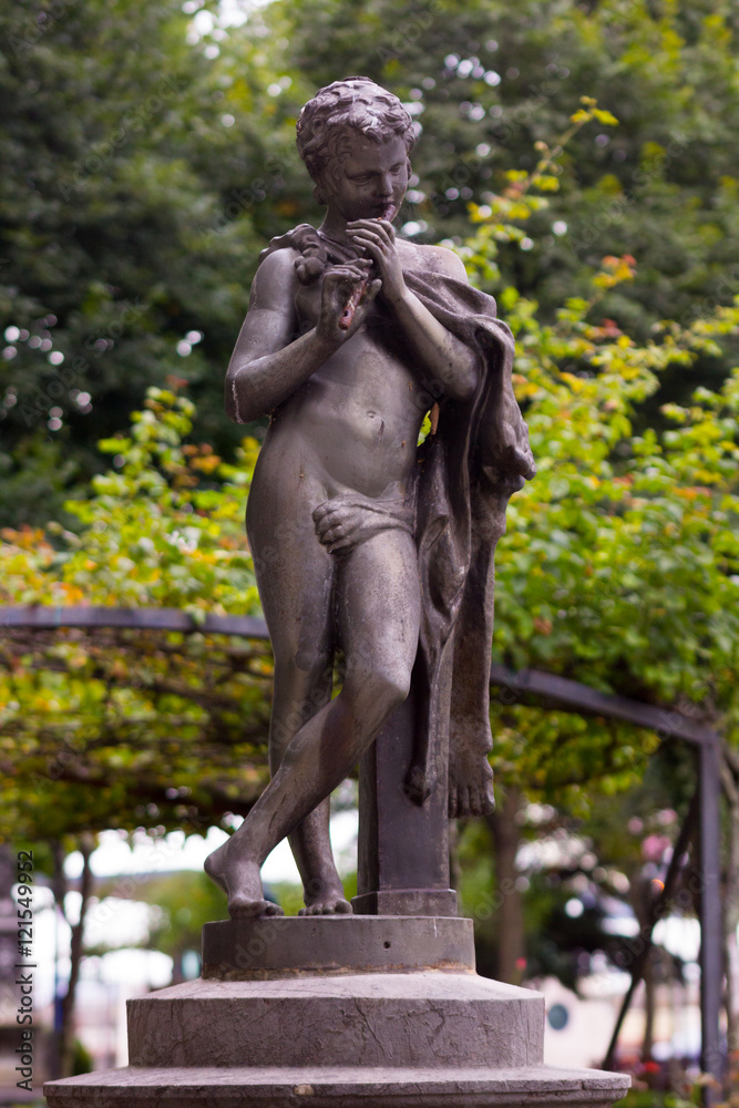 Young naked statue playing the flute