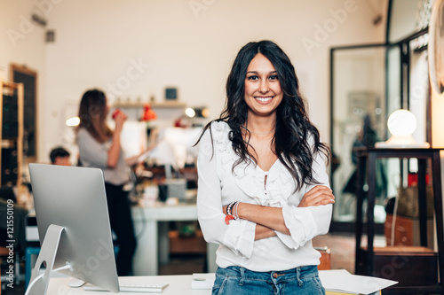 Portrait of smiling woman standing in modern office
